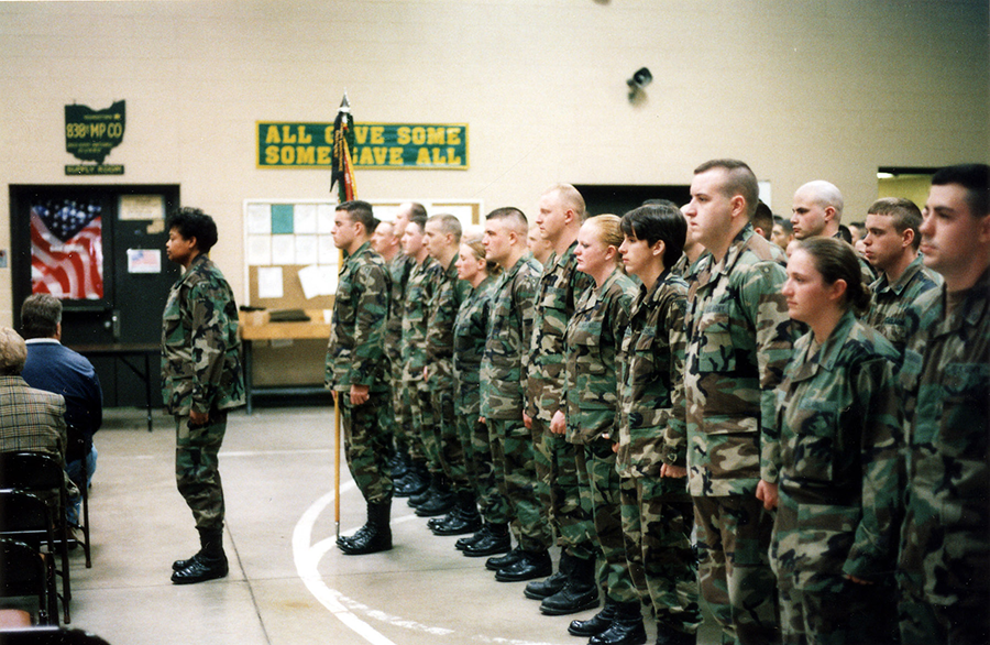 Color ohoto of Soldiers in camo standing at attention on drill floor from 2004.