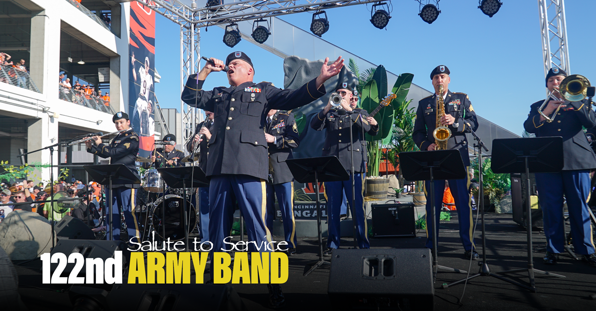 122nd Army Band sings and plays instruments on stage