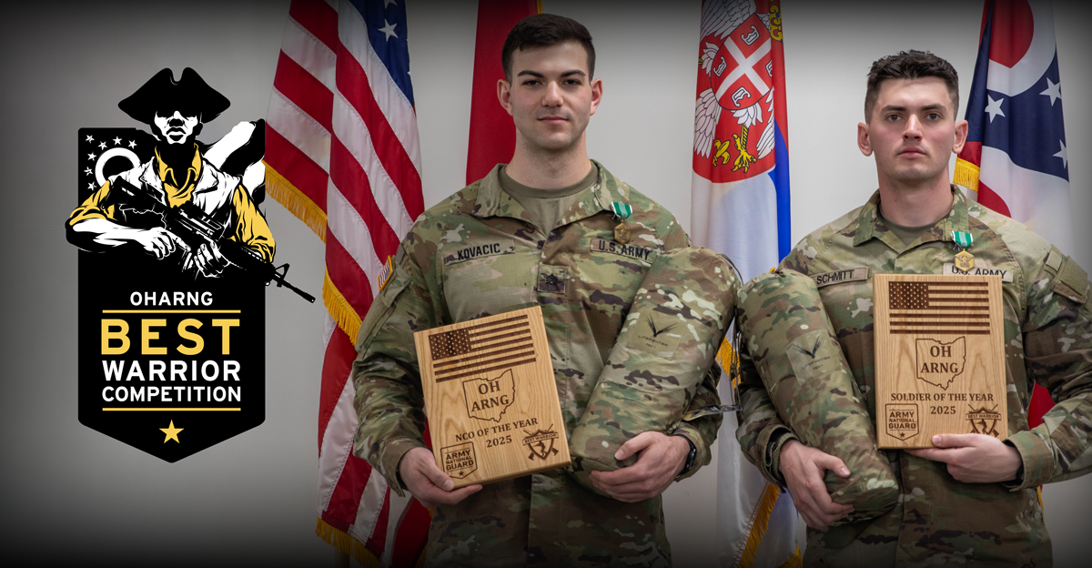 Two Soldiers stand side by side with awards