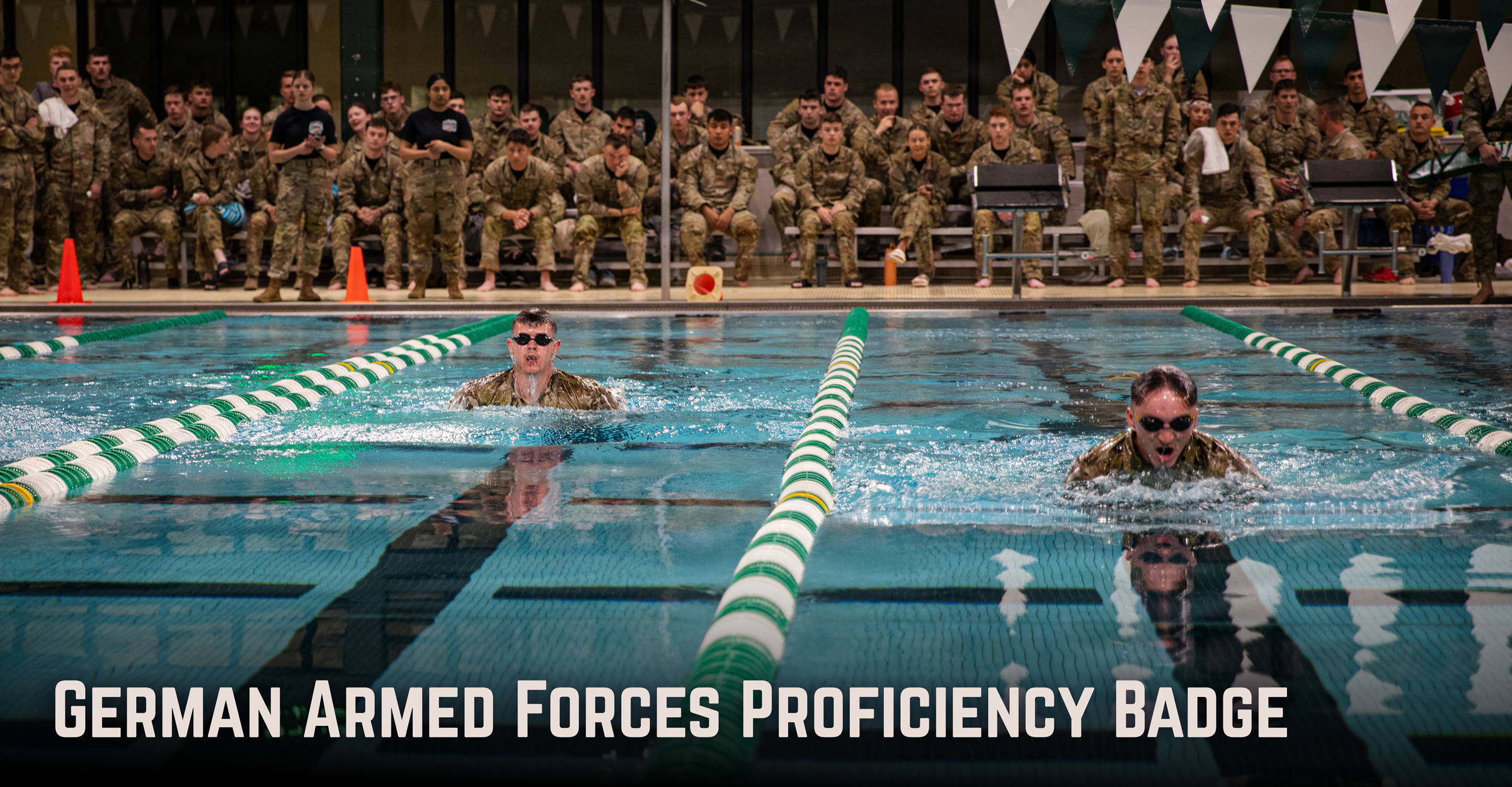 Soldiers swimming in indoor pool