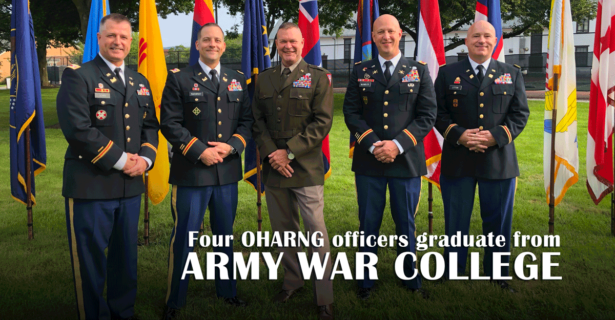 Ohio Army National Guard field grade officers pose in row in front of flags.