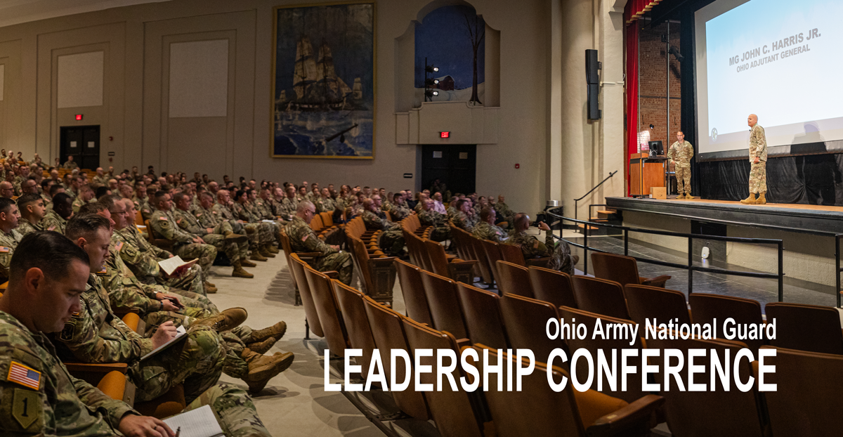 Soldiers sit in auditorium