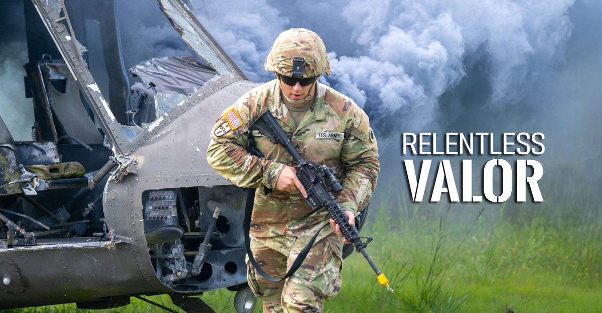 Soldier runs in front of helicopter holding a weapon