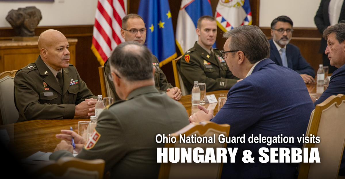 Ohio National Guard and Serbian government representatives sit around a table