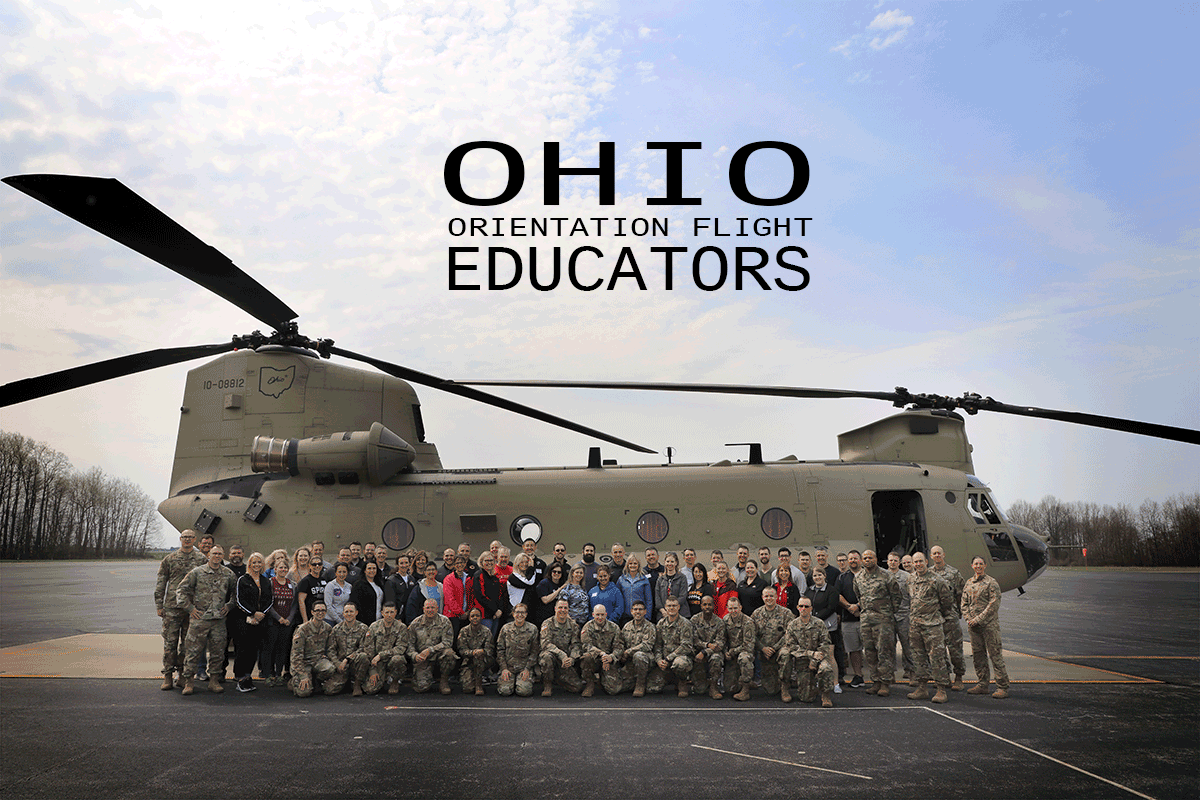 Group of Ohio educators stand in front of Chinook helicopter