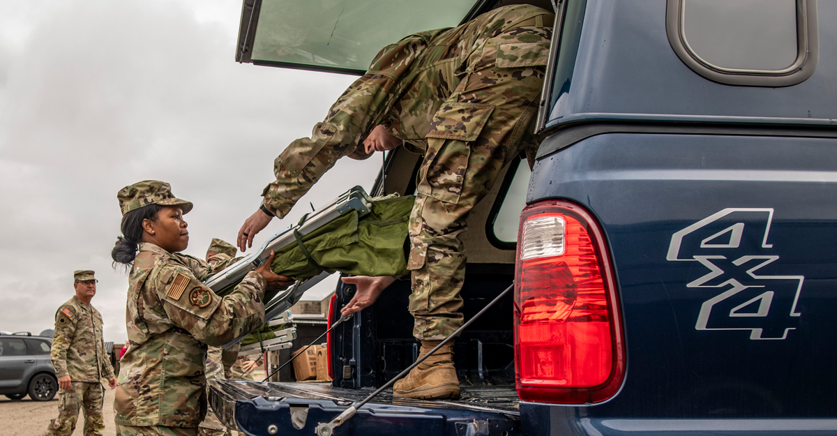 Airmen load the back of a truck.