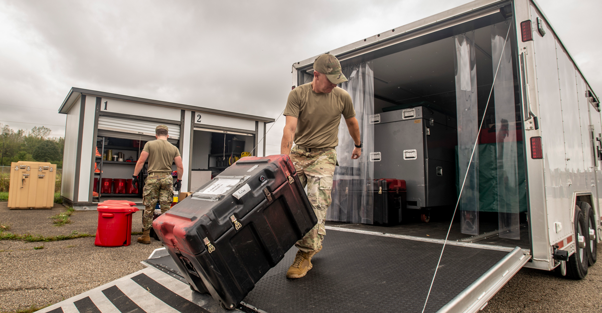 Airmen load trailers.