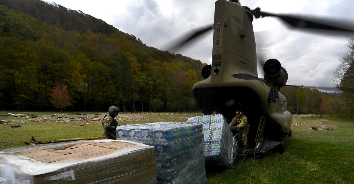 Airman load a CH-47 Chinook helicopter.