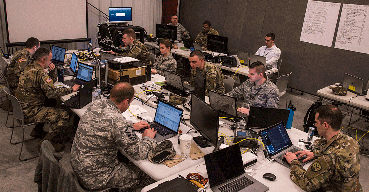 Room full of Guard members at computers.