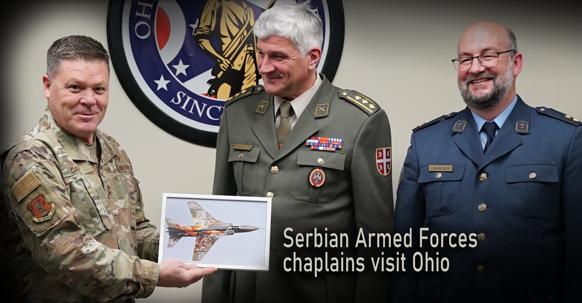 ONG Asst. Adj. Gen. for Air holds painting presented by 2 Serbian officials.
