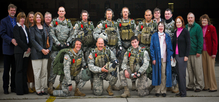 Soldiers with Company B, 2nd Battalion, 19th Special Forces Group (Airborne) pose with Family members of Chief Warrant Officer 3 (Maj.) H. Roger Mills Oct. 16, 2011, at Rickenbacker Air National Guard Base in Columbus, Ohio, prior to a military freefall jump onto H.R. Mills Drop Zone. After the jump, the drop zone was dedicated to Mills, a former commander of Company B, 2-19th, who died of injuries suffered during a static line airborne operation Oct. 24, 2010.
