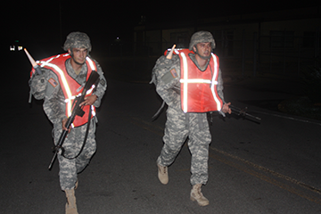 Warrant Officer Candidates Mark Sandbury (left), a North Canton, Ohio, resident, and Patrick Helderman, a Stow, Ohio, resident, finish a 6.2-mile road march. 