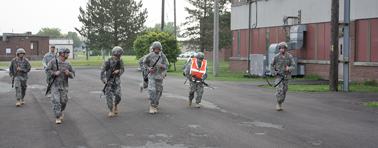 Soldiers in the Reserve Component Warrant Officer Candidate School help motivate the last of their comrades across the finish line of a 6.2-mile road march.