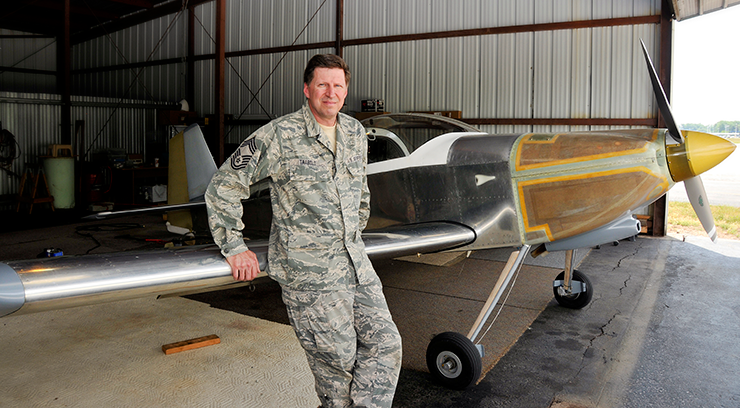 Chief Master Sgt. Jeff Trabold, 180th Fighter Wing airfield operations manager, stands with his hand-built Van's RV-6 that he completed in May.