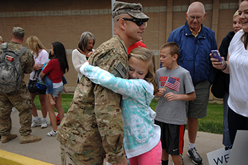 Clara Lundblad, 13, hugs her father, Sgt. Maj. Douglas Lundblad.