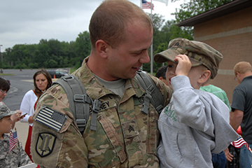 Sgt. Brandon Behney holds his son Declan, 3.