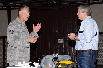 Tech. Sgt. Mark Groves (left), an aircrew flight equipment technician with the 121st Air Refueling Wing, shows equipment used by Ohio Air National Guard pilots to Dr. James Futrell, pastor of pastoral care at the Fairhaven Church in Centerville, Ohio.