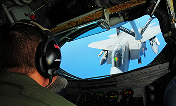 Ohio Air National Guard KC-135 Stratotanker preparing to provide aerial refueling to a group of F-15E Strike Eagle fighters.