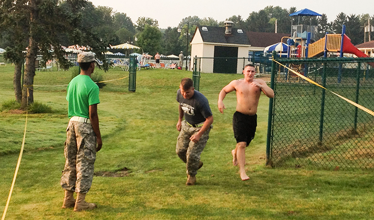 Ohio Army National Guard Spc. Steven J. Vondriska (center) prepares to be tagged in by teammate Sgt. Paul D. Bralek.