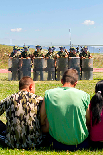 A squad of Serbian soldiers from 41st Infantry Battalion, 4th Army Brigade, face role players posing as peaceful civil protestors as they prepare to go through the evaluation lane.