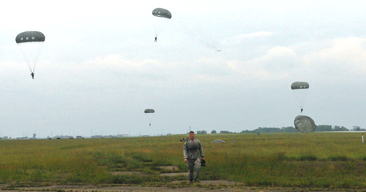 Members maneuver for a landing after jumping from more than 1,000 feet.