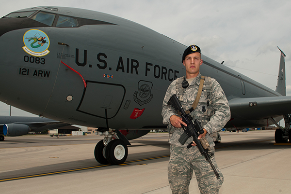 Airman 1st Class Joseph T. Nenadich, a member of the 121st Security Forces Squadron, stands in front of a KC-135 Stratotanker at Rickenbacker Air National Guard Base.