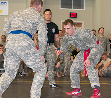 Staff Sgt. Andrew Komaromy (right) of the 174th Air Defense Artillery Brigade prepares to grapple his opponent.