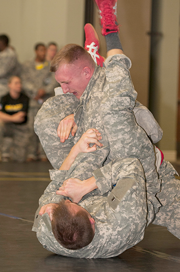 Staff Sgt. Andrew Komaromy (bottom) of the 174th Air Defense Artillery Brigade grapples Spc. Mathew Zaller of Company A, 1st Battalion, 145th Armored Regiment.