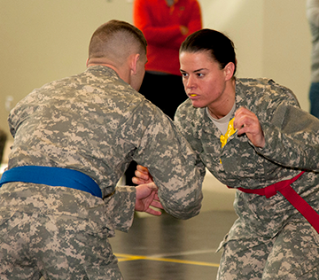 Spc. Kaitlin B. Torgerson (right) of the 1487th Transportation Company prepares to battle Sgt. Trevor Hale of the 737th Support Company.