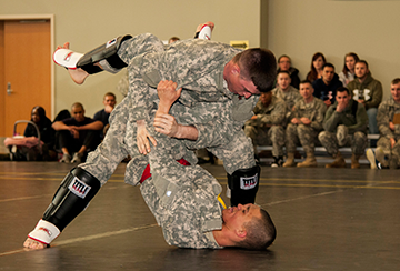 Spc. Zachery A. McCall (standing) of the 211th Maintenance Company grapples Sgt. David Z. Jackson of the 1486th Transportation Company.