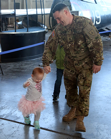 A Soldier with the Ohio National Guard's Company B, 3rd Battalion, 238th Aviation Regiment spends time with a Family member.