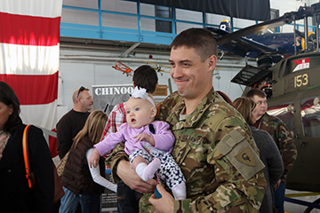 A Soldier with the Ohio National Guard's Company B, 3rd Battalion, 238th Aviation Regiment spends time with a Family member.