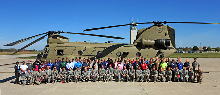 Attendees of the Ohio National Guard Joint Employer Event stand in front of a CH-47 Chinook helicopter.