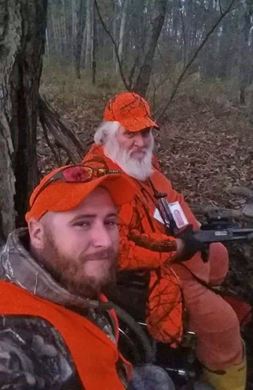 Michael Stewart (foreground) snaps a picture while hunting with his dad Tom during a Camp Ravenna Controlled Deer Hunt. (Photo courtesy of Michael Stewart)
