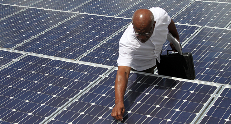 Ronald Gooch, energy specialist for the Ohio Adjutant General’s Department, inspects one of the more than 300 solar panels at the Maj. Gen. Robert S. Beightler Armory Aug. 11, 2016, in Columbus, Ohio. Solar power has been a part of the Ohio National Guard’s efforts to reduce energy consumption since 2009, with solar arrays currently at seven facilities throughout the state and plans to expand further. (Sgt. Andrew Kuhn, ONG)
