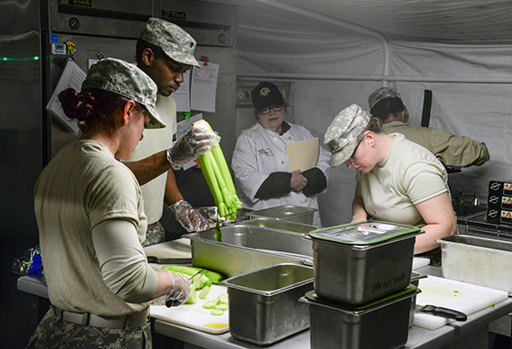Culinary specialists with Company D, 128th Support Battalion prepare a meal Feb. 27, 2016, in an Army mobile kitchen trailer at Camp Ravenna Joint Military Training Center. 