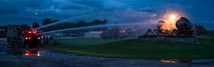 Ohio Army National Guard firefighters with the 295th and 296th Engineer Detachments train with the 513th Engineer Detachment in a live burn exercise in early morning darkness.