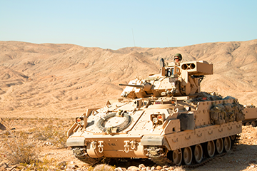 An M3 Bradley Cavalry Fighting Vehicle provides perimeter security during simulated combat operations.