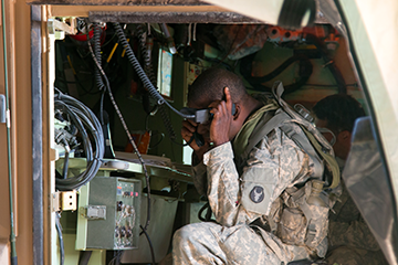 A Soldier with the 1st Battalion, 145th Armored Regiment monitors radio communications June 17, 2016, during simulated combat operations.
