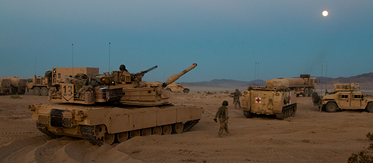 Soldiers with the 1st Battalion, 145th Armored Regiment prepare for a night assault.