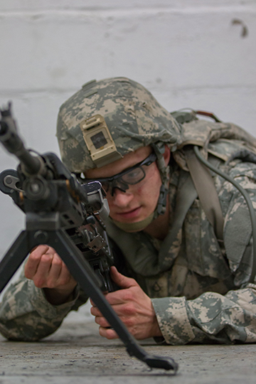 Pfc. Ryan Eiler of the Minnesota Army National Guard performs a functions check of the M249 Squad Automatic Weapon.