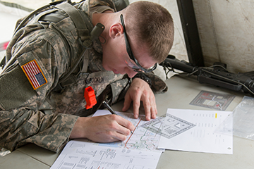 Spc. Dakota VanBrocklin of the Iowa Army National Guard plots his points.