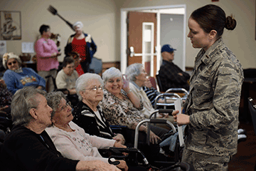 Second Lt. Kaitlyn Newkirk, a clinical nurse with the 180th Fighter Wing, speaks with veterans.
