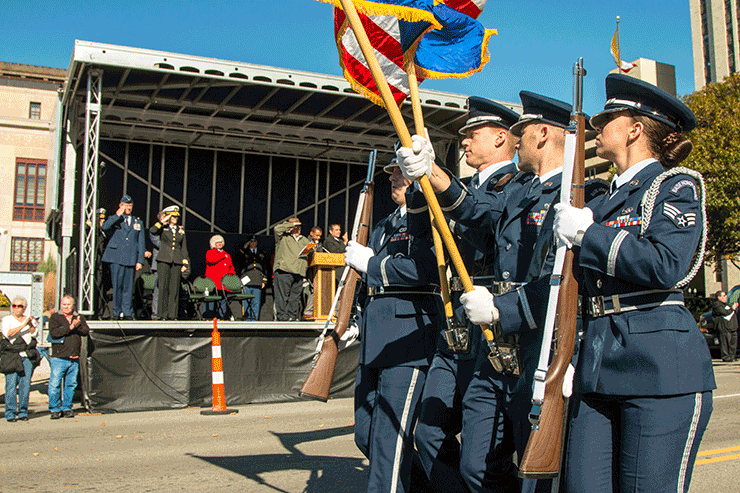 A color guard from the 121st Air Refueling Wing presents the U.S. flag for review while passing the grandstand