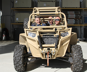 Lt. Gen. Jovica Draganić (left), Serbian Armed Forces deputy chief of general staff, and Djerdj Matkovic (back center), Serbian Ambassador to the United States, prepare for a ride in an all-terrain vehicle with a Soldier from Company B, 2nd Battalion, 19th Special Forces Group.