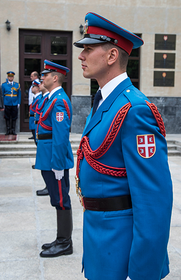 Members of the Serbian Armed Forces stand at attention during the arrival of Maj Gen. Mark E. Bartman.