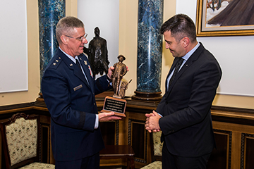 Bartman (left) presents a gift of a Minuteman statue to Serbian Defense Minister Zoran Djordjevic.