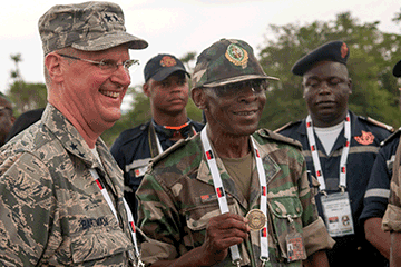 Maj. Gen. Mark E. Bartman (left), Ohio adjutant general, gives one of his coins to Brig. Gen. Jose Belchior da Silva of the Angolan Armed Forces.
