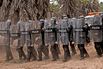 Members of the Angolan police forces demonstrate a response to a riot situation.