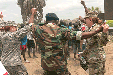 U.S. Air Force and Army members celebrate with members of the Angolan Armed Forces.